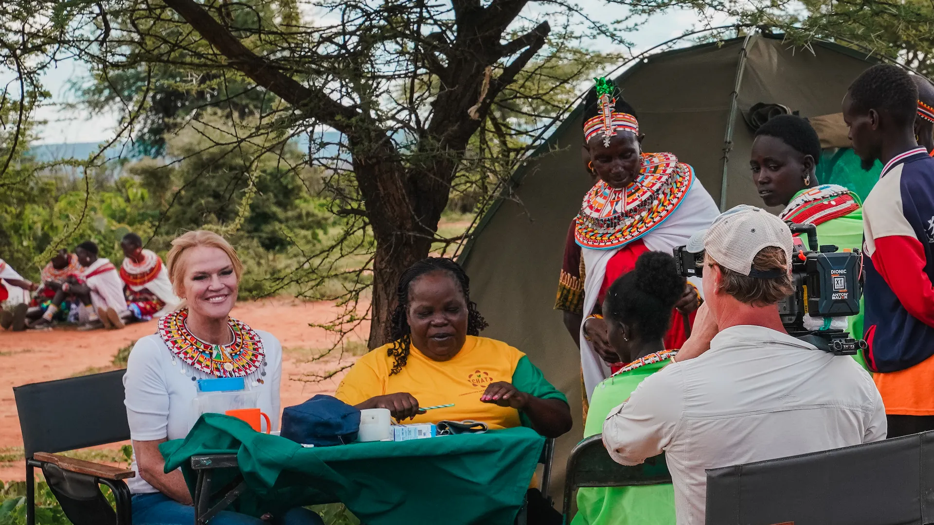 CHAT field director Rose Kimanzi treats patients as Kym watches on.